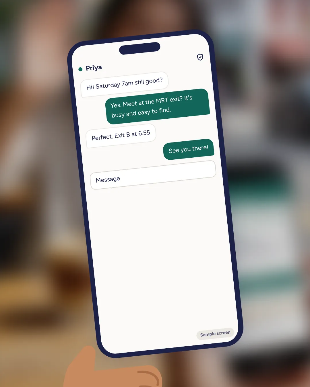 Phone in hand showing the chat sample screen